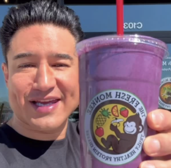 Mario Lopez holding a Fresh Monkee smoothie